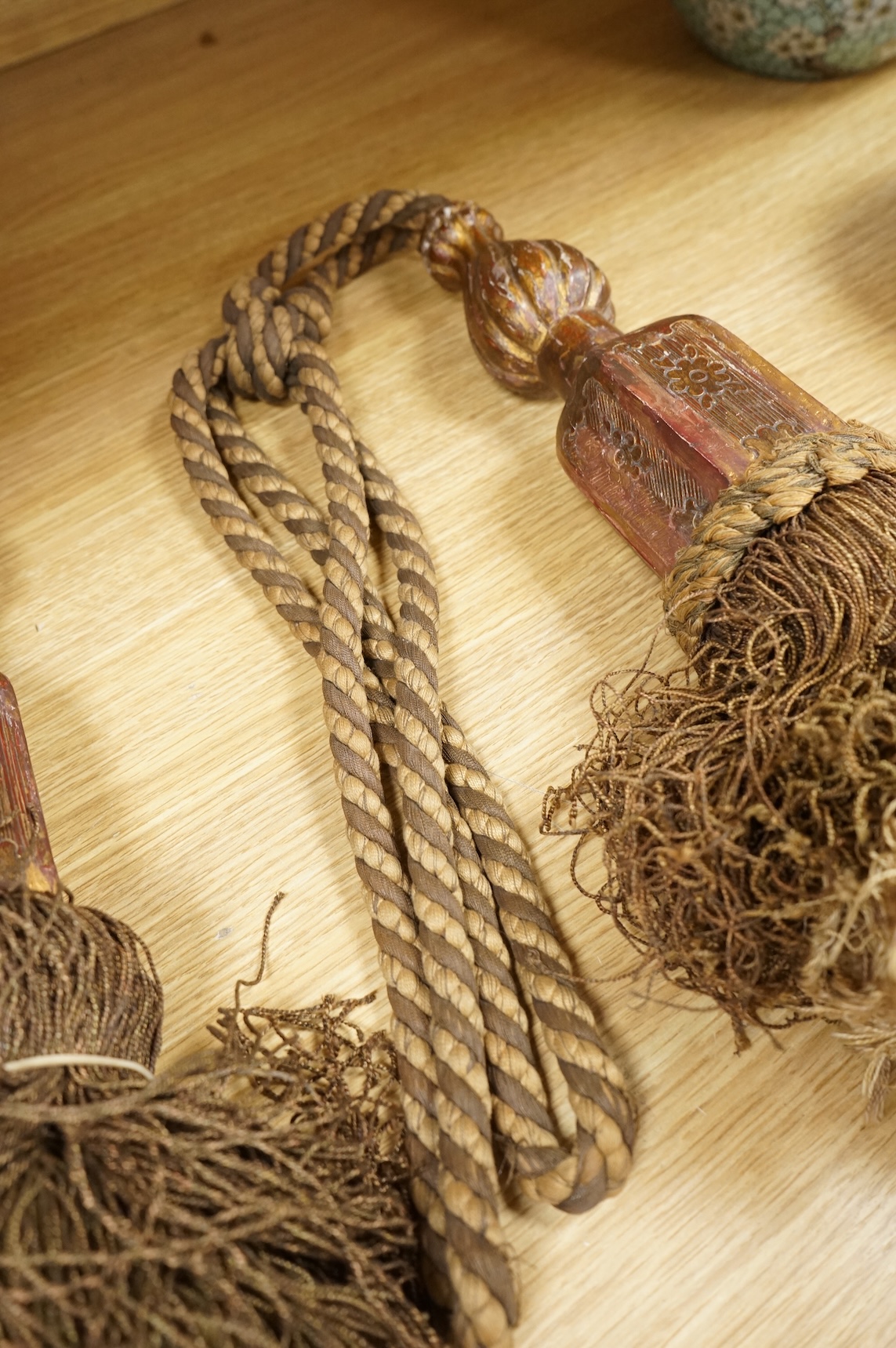 A pair of 19th century Venetian carved wood and tasseled tie-backs